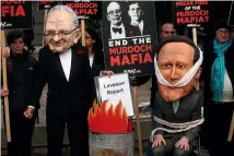  ?? ?? A protest group campaignin­g against the political dominance of Rupert Murdoch stage a mock burning of a copy of the Leveson Report into press culture and ethics after its release in 2012.