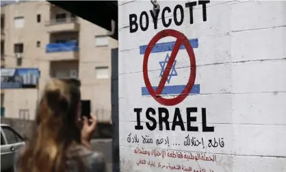  ??  ?? A sign on a wall in Bethlehem calling for a boycott of Israeli products from Jewish settlement­s. Photograph: Thomas Coex/AFP/Getty Images