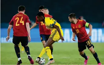  ?? Photo: Nampa/AFP ?? Stalemate…Sweden’s forward Alexander Isak (c) dribbles past Spain’s defender Aymeric Laporte (L) and Spain’s defender Jordi Alba (R) during their UEFA EURO 2020 Group E match at the La Cartuja Stadium in Sevilla on Monday.