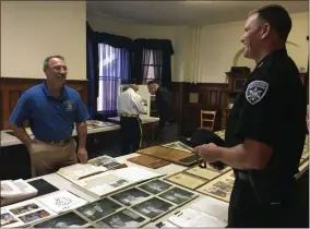  ?? CHARLES PRITCHARD - ONEIDA DAILY DISPATCH ?? Local residents and officials look over historic pictures and documents at the Canastota American Legion 100th anniversar­y on Saturday.