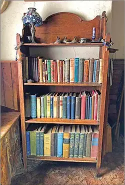  ?? JON HAMMOND / FOR TEHACHAPI NEWS ?? A bookcase holding some of my favorite old volumes. The bookcase itself is made of oak, actually folds up when empty, and was made in the late 1800s.