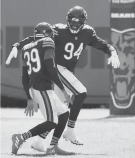  ?? NAM Y. HUH/AP ?? Outside linebacker Robert Quinn (94), in his first game with the Bears, and safety Eddie Jackson made some impressive plays against the Giants.