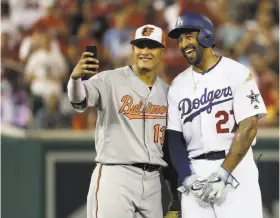  ??  ?? Shortstop Manny Machado, rumored to be on his way to Los Angeles, takes a selfie with a possible future teammate, Dodgers outfielder Matt Kemp, during the second inning of Tuesday’s All-Star Game.
