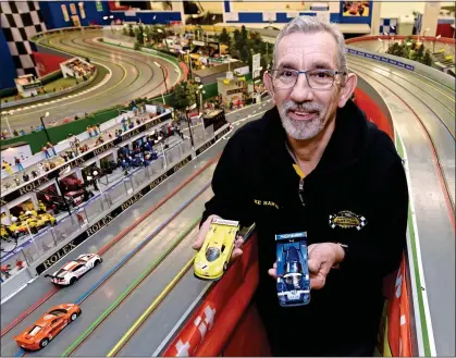  ??  ?? NEED FOR SPEED: Mike Harvey has spent years building a 97ft race circuit, with even a model of Murray Walker, top