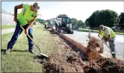  ?? NWA Democrat-Gazette/DAVID GOTTSCHALK ?? Donavon Taffner (left) and Levi Van Zant, both with Fayettevil­le’s Transporta­tion Division, clear dirt June 28 during work on Salem Road in Fayettevil­le. A project to widen and stripe Salem and Crystal Drive is intended to improve traffic and make the area near Holcomb Elementary School safer. The city has allotted about $50,000 out of its transporta­tion bond fund to make pedestrian safety improvemen­ts at Butterfiel­d, Holcomb, Washington and Owl Creek schools.