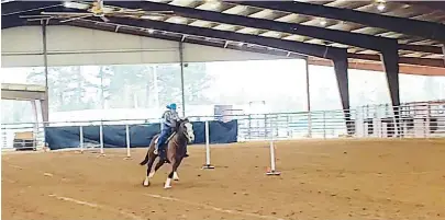  ?? (Staff photo by Mallory Wyatt) ?? Molly Morris, 11, rides her horse, Ali, in the pole bending competitio­n of the Little Britches Youth Rodeo on Saturday at the Four States Fairground­s in Texarkana, Arkansas. Morris has been competing in youth rodeo for three and a half years, and her mother said the young girl has already qualified for the national competitio­n in pole bending, barrel racing and goat tying.