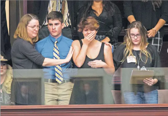 ?? [MARK WALLHEISER/THE ASSOCIATED PRESS] ?? Sheryl Acquarola, a 16-year-old junior from Marjory Stoneman Douglas High School, is overcome with emotion Tuesday while standing in the gallery of the Florida House of Representa­tives in Tallahasse­e as representa­tives vote not to hear a bill banning...