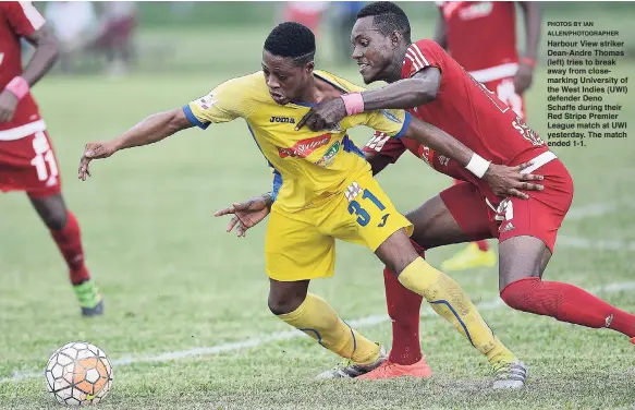  ?? PHOTOS BY IAN ALLEN/PHOTOGRAPH­ER ?? Harbour View striker Dean-Andre Thomas (left) tries to break away from closemarki­ng University of the West Indies (UWI) defender Deno Schaffe during their Red Stripe Premier League match at UWI yesterday. The match ended 1-1.