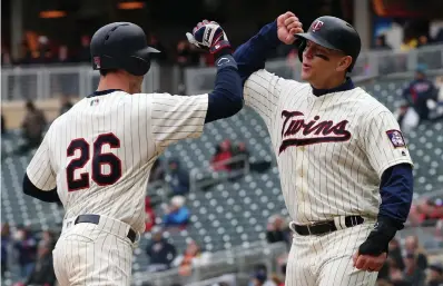  ?? Associated Press ?? ■ Minnesota Twins' Max Kepler (26) is congratula­ted by teammate Logan Morrison after Kepler's two-run home run off Houston Astros pitcher Lance McCullers Jr. in the fourth inning of a baseball game Wednesday in Minneapoli­s.