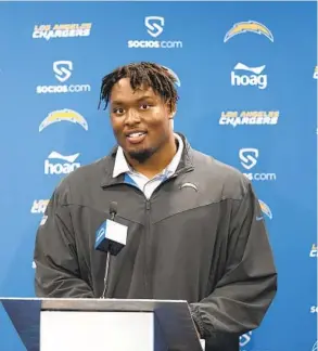  ?? KYUSUNG GONG AP ?? Los Angeles Chargers’ first-round pick Zion Johnson answers questions at a news conference at the team’s training facility in Costa Mesa on Friday.