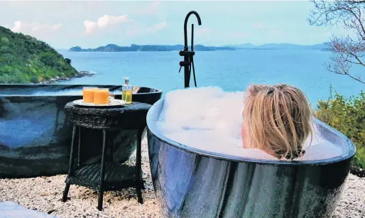  ?? PHOTO: BRUCE MUNRO ?? Splash of luxury . . . The divine decadence of twin outdoor tubs with an expansive view of sea, islands and sky.