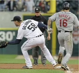  ?? Associated Press ?? Jim Joyce watches the play that would change his life: Armando Galarraga covers first base as the Indians’ Jason Donald sprints to the bag.