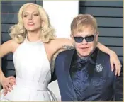  ?? Nina Prommer
European Pressphoto Agency ?? LADY GAGA, who sang at the Oscars, drapes an arm around Elton John at the party in Beverly Hills.