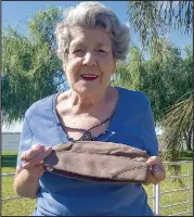  ??  ?? Yvonne Nicholson with a US WWII flying ace’s cap, that had been thrown to her father in law while working alongside the American air force in Darwin in 1942 and was later found to belong to US Lt George Preddy.