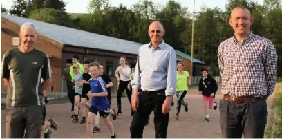  ??  ?? From front left Chair of Rossendale Harriers Graham Wright, Rossendale Rays Paul Mulderrig and Chief Executive of Rossendale Leisure Trust Ken Masser with members of Rossendale Harriers in the background.