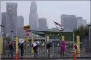  ?? DAMIAN DOVARGANES — THE ASSOCIATED PRESS ?? Los Angeles Unified School District, LAUSD teachers and Service Employees Internatio­nal Union 99 (SEIU) members strike during heavy rain outside the Edward R. Roybal Learning Center in Los Angeles Tuesday, March 21, 2023.