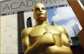  ?? PHOTO BY MATT SAYLES — INVISION — AP, FILE ?? In this file photo, an Oscar statue appears outside the Dolby Theatre for the 87th Academy Awards in Los Angeles.