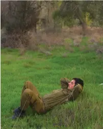  ??  ?? A RESERVIST waits in a field before heading home after Operation Pillar of Defense in 2012.