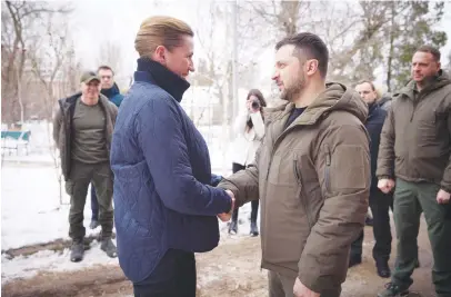  ?? (Ukrainian Presidenti­al Press Service/handout via Reuters) ?? UKRAINIAN PRESIDENT Volodymyr Zelensky welcomes Danish Prime Minister Mette Frederikse­n before visiting Ukrainian servicemen at a military hospital in Mykolaiv yesterday.