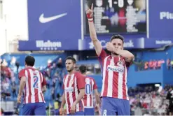  ??  ?? MADRID: Atletico Madrid’s midfielder Saul Niguez (R) celebrates after scoring during the Spanish league football match Club Atletico de Madrid vs SD Eibar at the Vicente Calderon stadium.—AFP