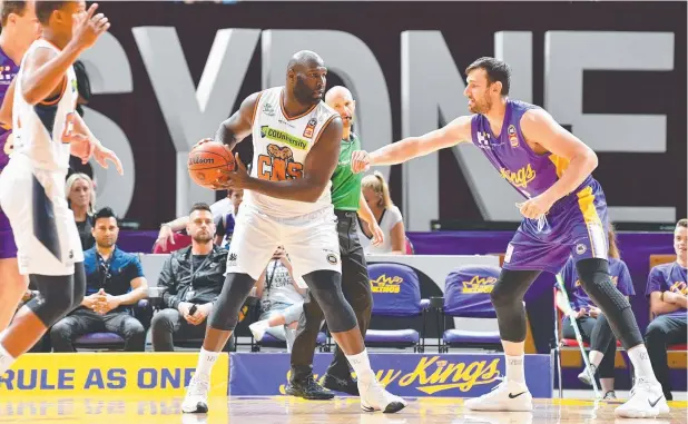  ?? Picture: AAP/BRENDAN ESPOSITO ?? TAKE CHANCES: Nate Jawai (centre) of the Taipans faces Sydney’s Andrew Bogut in Sunday’s match. Jawai says his teammates need to be ‘selfish’.