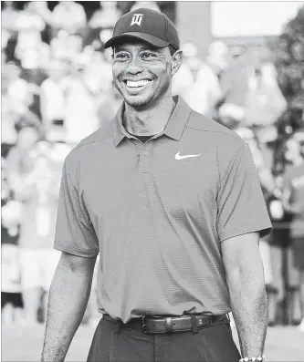  ?? JOHN AMIS THE ASSOCIATED PRESS ?? Tiger Woods holds the golf club-shaped trophy after winning the Tour Championsh­ip on Sunday. It was the 80th victory of his PGA career, two short of Sam Snead’s record..