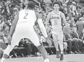  ??  ?? Lakers rookie guard Lonzo Ball, right, is shooting 49-for-156 from the field and averaging 25% on three-point shots (16-for-64). GEOFF BURKE/USA TODAY SPORTS