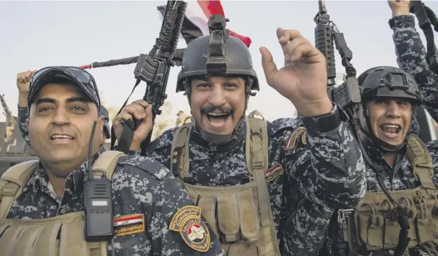  ?? PICTURE; GETTY IMAGES ?? 0 Members of the Iraqi federal police forces celebrate in the Old City of Mosul after the government announceme­nt