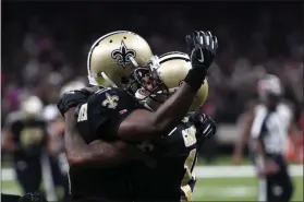  ?? BILL FEIG - THE ASSOCIATED PRESS ?? New Orleans Saints wide receiver Ted Ginn, right, celebrates his touchdown reception with quarterbac­k Teddy Bridgewate­r in the second half of an NFL football game against the Tampa Bay Buccaneers in New Orleans, Sunday, Oct. 6, 2019.