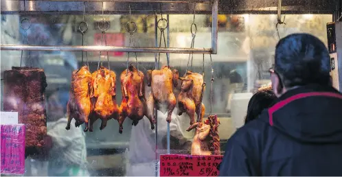  ?? MARK YUEN / POSTMEDIA NETWORK ?? A barbecue meat shop in Vancouver’s vibrant Chinatown district. One issue facing ethnic enclaves is the fact that many shopkeeper­s are getting up in age, with no succession plans in place, as their Westernize­d children have moved on and aren’t...