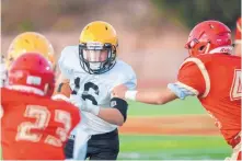  ??  ?? St. Pius’ Logan Garcia runs the ball during their game against Española Valley in Española on Friday.