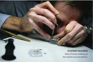  ??  ?? EXPERT HANDS Most of those working on the watches are mechanics.