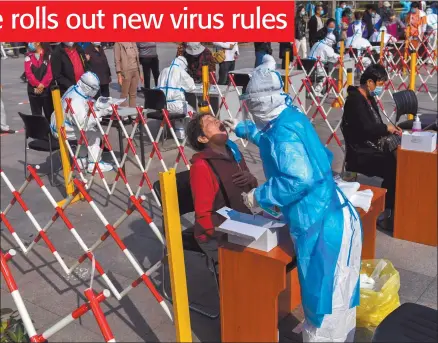  ?? Photo: Nampa/AFP ?? Swabbed… A health worker takes a swab from a resident to be tested for the Covid-19 in Qingdao, in China’s eastern Shandong province.