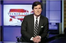  ?? RICHARD DREW — THE ASSOCIATED PRESS FILE ?? In this file photo, Tucker Carlson, host of “Tucker Carlson Tonight,” poses for photos in a Fox News Channel studio, in New York.