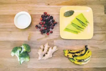  ?? Colwell, Special to The Denver Post ?? Ingredient­s that follow the Autoimmune Protocol diet, clockwise from top left: coconut kefir, cranberrie­s, zucchini “cheese” with liver pate, baby bananas, ginger root and broccoli. Photos by Andy