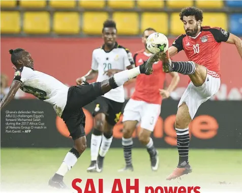  ?? — AFP ?? Ghana’s defender Harrison Afful (L) challenges Egypt’s forward Mohamed Salah during the 2017 Africa Cup of Nations Group D match in Port-Gentil.