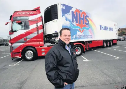  ??  ?? Looking good
Stuart Gordon ( Director Gordon Transport Solutions) with the new look truck in Ayr Hospital car park