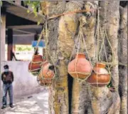  ??  ?? Earthen urns containing ashes of Covid-19 fatalities hang from a tree at a crematoriu­m in Moradabad, UP on May 4.