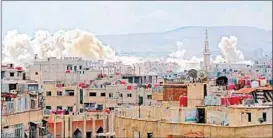  ?? RAMI AL SAYED/GETTY-AFP ?? Smoke billows from a refugee camp after government attacks Sunday in Damascus.