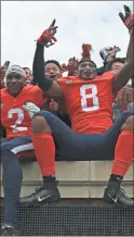  ?? Va. / The Daily ProgressZa­ck Wajsgras ?? Virginia’s wide receiver Joe Reed, wide receiver Hasise Dubois celebrate with fans after Virginia’s win against North Carolina, on Saturday in Charlottes­ville,