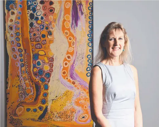  ??  ?? Dr Wendy Garden with some art work from the Hot! exhibition, which will showcase works from the MAGNT collection