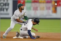  ?? NOAH K. MURRAY — THE ASSOCIATED PRESS ?? New York Yankees’ Isiah Kiner-Falefa steals second base against A’s shortstop Elvis Andrus during the fifth inning on Tuesday in New York.