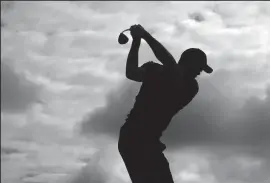  ?? K.C. ALFRED/TRIBUNE NEWS SERVICE ?? Tigers Woods hits balls on the range at the Torrey Pines Golf Course as he prepares for the Farmers Insurance Open on Tuesday.