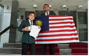  ??  ?? Harris (left) and Warinthorn pose with their medals, certificat­es and the Jalur Gemilang after winning the award.