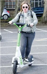  ??  ?? ●● Flora Byatt tries out one of the e scooters