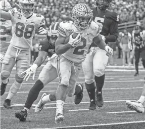  ?? TONY DING/AP ?? Ohio State running back J.K. Dobbins, scoring a TD against Michigan, has rushed for 1,829 yards and 20 TDs this season.