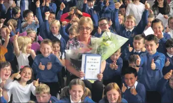  ??  ?? Mrs Stewart was presented with a ‘ This Is Your School Life’ book on her last day of school before retiring.