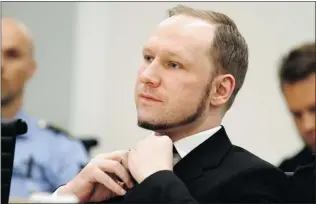  ?? HEIKO JUNGE/ NTB SCANPIX/ POOL/ REUTERS ?? Anders Behring Breivik adjusts his tie as the Oslo Court sentences him to 21 years in prison Friday.