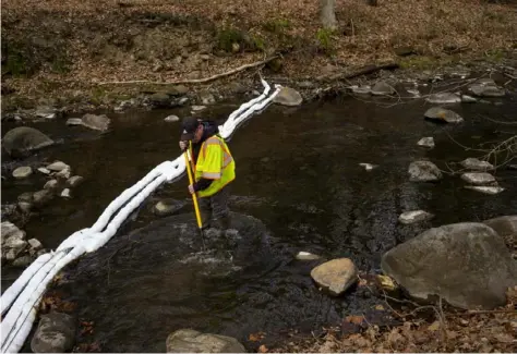  ?? Getty Images ?? Ron Fodo, Ohio EPA Emergency Response, looks for signs of fish and also agitates the water in Leslie Run creek to check for chemicals that have settled at the bottom following the train derailment prompting health concerns in East Palestine, Ohio.