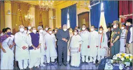  ?? ANI ?? West Bengal governor Jagdeep Dhankhar, along with chief minister Mamata Banerjee and the newly sworn-in ministers, during a ceremony at Raj Bhavan in Kolkata on Monday.